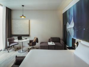 a room with a bed and a table and chairs at Novotel Mexico City Toreo in Mexico City +120 photos