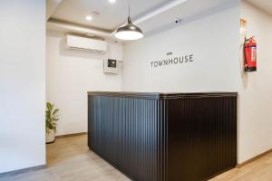 a room with a large black desk in front of a wall at Townhouse Lords Regency in Indore