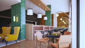 a restaurant with colorful chairs and tables in a cafeteria at DoubleTree by Hilton Laredo in Laredo