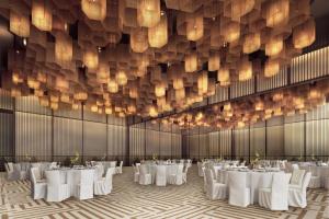 a banquet hall with white tables and chandeliers at The Reserve Hotel Luoyang, Curio Collection By Hilton in Luoyang +11 photos