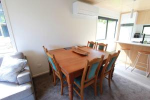 a dining room with a wooden table and chairs at Modern Tata Beach Escape - Spacious New Retreat in Tata Beach