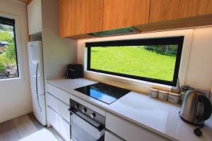 a kitchen with a large window in a small kitchen at Modern Tata Beach Escape - Spacious New Retreat in Tata Beach