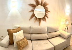 a living room with a white couch and a mirror at Villa Flamingo in Arguineguín