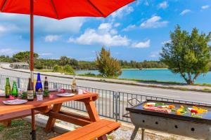 ein Picknicktisch mit Sonnenschirm neben einer Straße in der Unterkunft URUMA DOME Neptune9 in Uruma + 20 Fotos