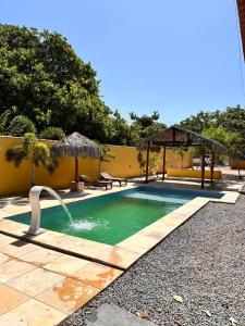 a swimming pool with a water fountain at Maruá Pousada da Lagoa in Jijoca de Jericoacoara