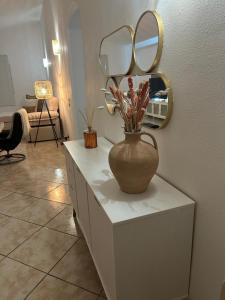 a vase sitting on a dresser with a mirror at Villa Flamingo in Arguineguín