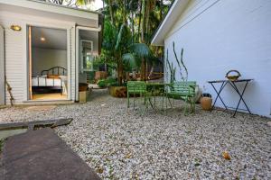 a patio with a table and chairs next to a building at Romantic Escape l Firepit & Views l Nova Escapes in Goonengerry