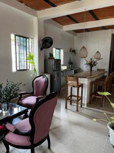 a living room with two chairs and a table at Isla Rosa Coveñas in Coveñitas +18 photos
