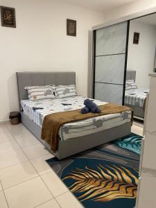 a bedroom with a bed and a mirror at Homestay Q Haven in Kuantan