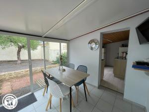 a dining room with a table and chairs at Charmante maison proche plage et forêts - FR-1-426-594 in La Barre-de-Monts