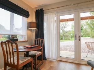 Church LeighにあるThe Lodge at Middleton Houseのダイニングルーム(テーブル付)、ガラスのスライドドア