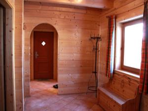 a hallway in a log cabin with a door at Holiday village Wildschönau in Kitzbühel Alps in Niederau +19 photos