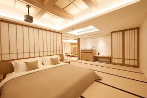 a bedroom with a large bed in a room at Qinghai Xisu in Dalian