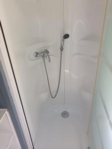 a shower in a bathroom with a glass door at Camping DEL MAR in Argelès-sur-Mer