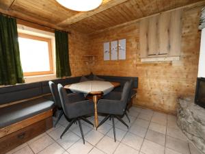 a dining room with chairs and a table and a tv at Chalet in Zillertal near Hochzillertal Ski Area in Zellberg