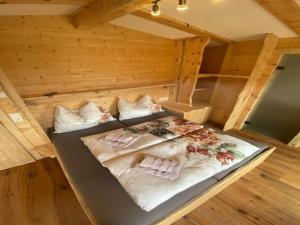 a bed in a wooden room in a cabin at Chalet in Zillertal near Hochzillertal Ski Area in Zellberg +59 photos