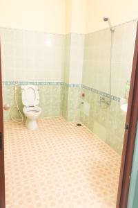 a bathroom with a toilet and a shower at Thanh Tùng Hotel HCM in Ho Chi Minh City