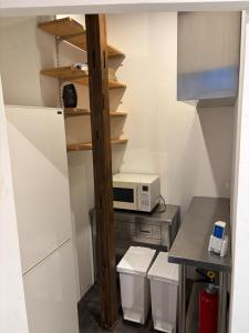 a small kitchen with a microwave and a counter at Kamakura S house in Yokohama