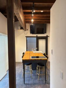 a conference room with a wooden table and chairs at Kamakura S house in Yokohama