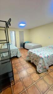 a room with two beds and a ladder in it at Hall dos parques in Belém