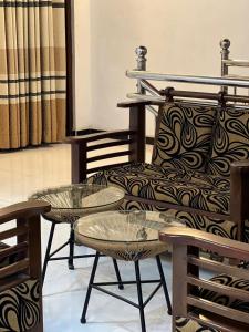two tables and a couch in a room at Ella Bungalow in Ella