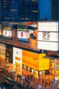 a large building with people walking in front of it at The Panda Artisan, Taikoo Li Xilia Hotel in Chengdu