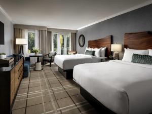 a hotel room with two beds and a television at Fairmont Chateau Whistler in Whistler