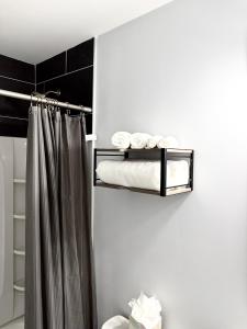 a bathroom with a shower curtain and towels at Bright, Cozy & Convenient - Minutes from UAB, Airport and Downtown Fun! in Birmingham