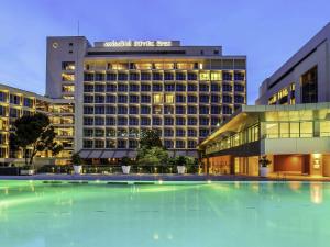 a hotel with a large pool in front of a building at Swissotel Buyuk Efes Izmir in Izmir