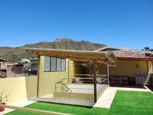 a view of a house with a patio with grass at In the heart of Vilcabamba House don Tuquito in Vilcabamba