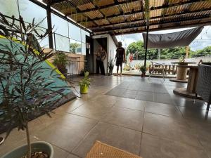 a couple of people standing in a building with plants at Casa ZANATE in Guatemala