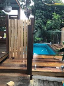 a wooden fence next to a swimming pool at Coastal 4 bedroom Sawtell home with Pool in Sawtell