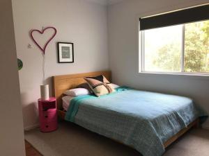 a bedroom with a bed with a heart balloon on the wall at Coastal 4 bedroom Sawtell home with Pool in Sawtell