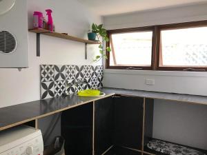 a kitchen with a counter top and a window at Coastal 4 bedroom Sawtell home with Pool in Sawtell +4 photos