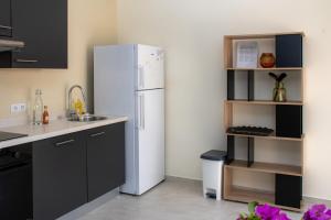 a kitchen with a white refrigerator in a room at WaraWara Mini resort in Jan Thiel