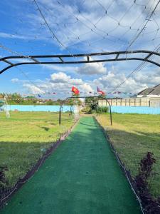 a walkway through a field with a fence at 8ເຮືອນພັກ 8Hotel 8号旅馆 in Vientiane