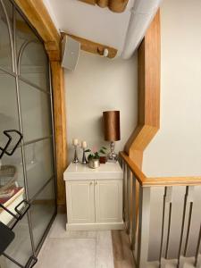 a room with a table with a lamp on it at Suites Modernas Coloniales en el Centro Histórico de Cuenca in Cuenca +52 photos