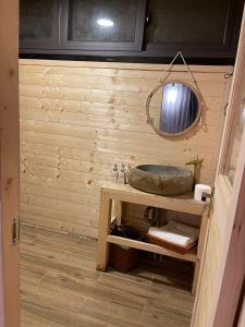 a bathroom with a sink and a mirror at Son Bá Mười Ecolodge 