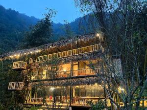 a building with lights on the side of it at Son Bá Mười Ecolodge 