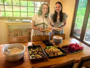 two women standing in front of a table with food at Nongtao Homestay in Chiang Mai