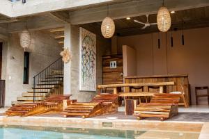 a pool with chairs and a table and stairs at Casa Ampa Zikatela- Brisas de Zicatela- Puerto Escondido in Brisas de Zicatela