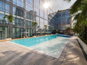 a large swimming pool in front of a building at Fairmont Makati in Manila