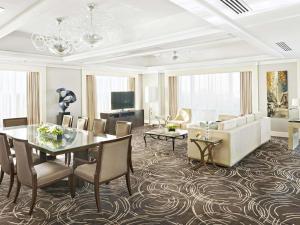 a living room with a dining table and a couch at Fairmont Makati in Manila