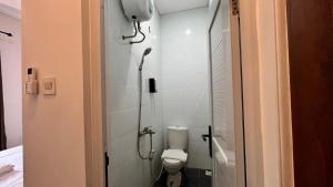 a small bathroom with a toilet and a shower at Hause of Bejo Yogyakarta in Demangan