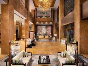 a hotel lobby with couches and a chandelier at Fairmont Beijing in Beijing