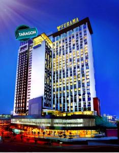 a tall building with a sign on top of it at Tarragon Family Suite Apartment in Kuala Lumpur