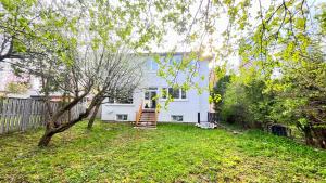 a white house with a staircase in a yard at Modern suite with private bathroom Yonge Finch sub in Bélanger