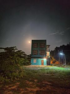 a building at night with a street light at Homestay IJAA in Marang