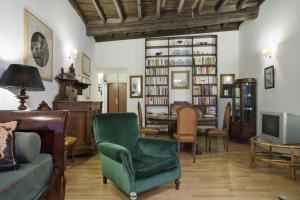 een woonkamer met een groene stoel en een tafel bij Locappart Colosseo / Esquilino in Rome