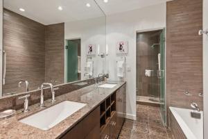 Un baño con dos lavabos y un espejo grande. en Center of Aspen 1 BR with AC Sundeck Hot-Tub, en Aspen